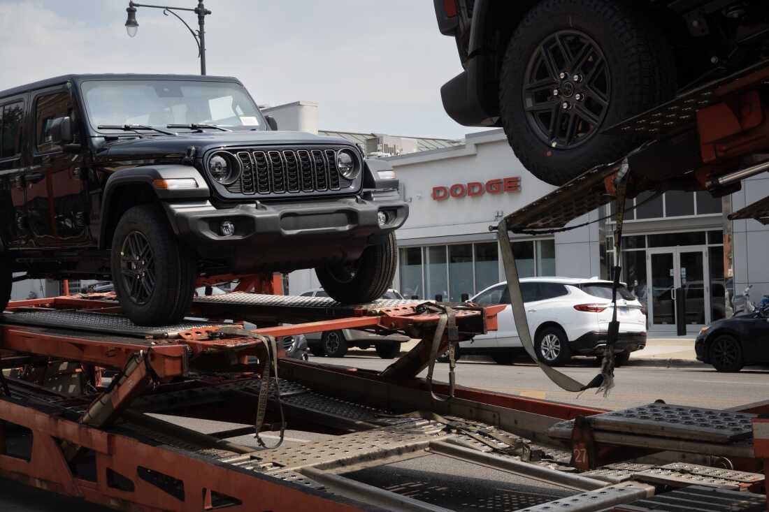 Jeeps are delivered to a dealership in Chicago on June 20, 2024. Stellantis, the parent company of Jeep, reported disappointing earnings for the first half of 2024.